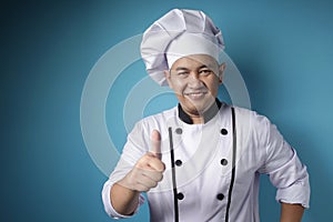 Asian Chef Smiling at Camera and Shows Thumbs Up Gesture