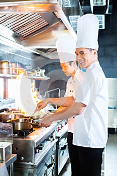 Asian chefs cooking in Restaurant