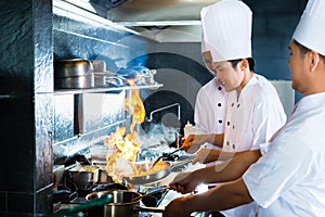 Asian chefs cooking in Restaurant