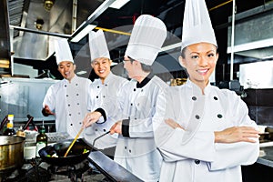 Asian Chefs in hotel restaurant kitchen