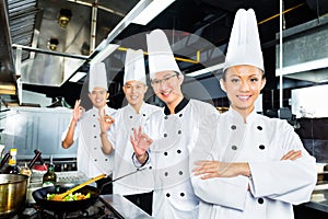 Asian Chefs in hotel restaurant kitchen