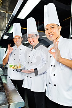 Asian Chefs in hotel restaurant kitchen