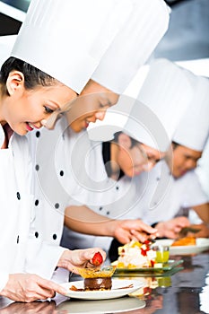 Asian Chefs in restaurant kitchen cooking