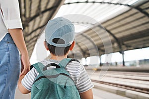 Asian Child boy and his mother waiting for the train