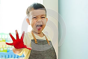 Asian child boy laughing with painted hands