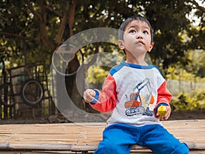 Asian child boy looking up to the sky with happy face.