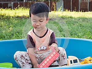 Asian child boy smiling with happy face outdoor with natural background.