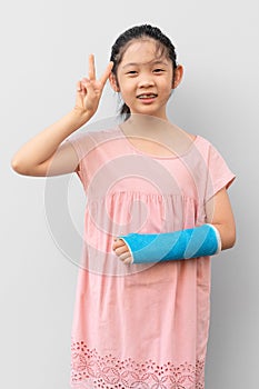 Asian Child with Broken Arm in Cast with Smiling Face Expression