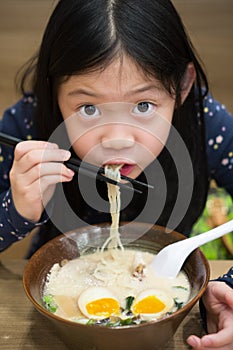 Asian Child Eating Ramen or Noodle Bowl