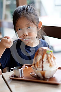 Asian Child Enjoys Eating Hawaiian Shave Ice Frozen Dessert