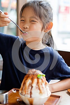 Asian Child Enjoys Eating Shave Ice Frozen Dessert