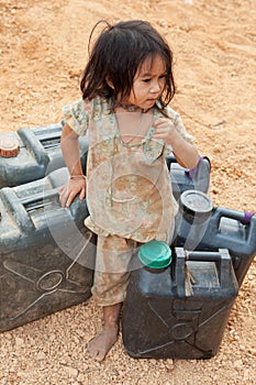 Asian child with gasoline canister