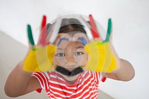 Asian child girl with colorful painted hands make heart shape with fun and love