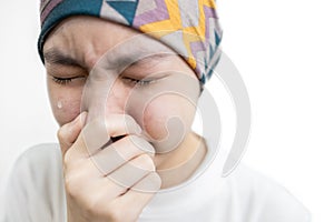 Asian child girl covers her head with a cloth,lady suffering from disease of Acute leukemia cancer,Depressed stressed female