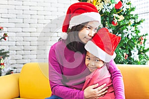 Asian child girl hugging her mother with love in Christmas celebration