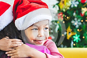 Asian child girl hugging her mother with love in Christmas celebration