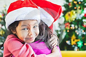 Asian child girl hugging her mother with love in Christmas celebration