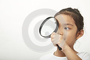 asian child girl with a magnifying glass