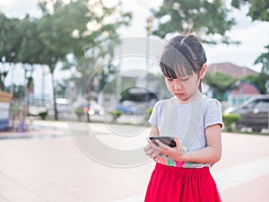 Asian child girl play smart phone