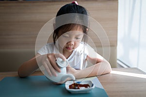 Asian Child, Girl, Pouring Soy Sauce