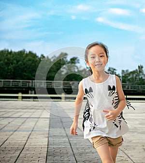 Asian child girl running out door with smile