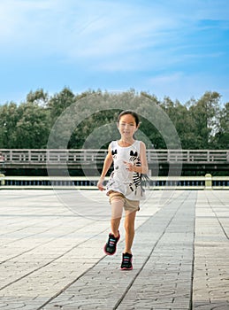Asian child girl running out door with smile