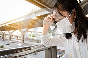 Asian child girl suffer from headache with the weather is very hot and air pollution,allergy to dust, feel sick,dizzy,fainting, photo