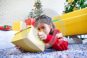 Asian child girl surprise with gift and holding beautiful gift box in hand on Christmas celebration