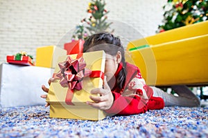 Asian child girl surprise with gift and holding beautiful gift box in hand on Christmas celebration