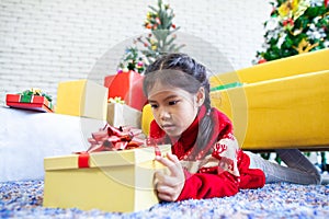 Asian child girl surprise with gift and holding beautiful gift box in hand on Christmas celebration