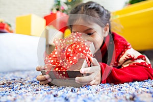 Asian child girl surprise with gift and holding beautiful gift box in hand on Christmas celebration