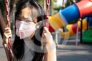 Asian child girl wearing protective mask,problems of toxic smog,fine dust,air pollution,PM2.5,Bangkok in air pollution,danger to