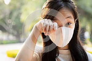 Asian child girl wearing protective medical mask,people with dirty hands,wash hands thoroughly before touching,rubbing the eyes,