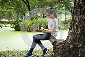 Asian child girl writing message on sheet of white paper in clipboard to vent her feelings,reduce stress,rage, female people have