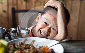 Asian child having lunch at the restaurant