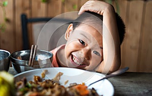 Asian child having lunch at the restaurant photo