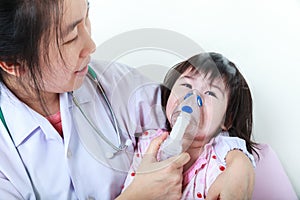 Asian child having respiratory illness with inhaler. Sad girl cr