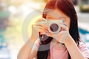 Asian Child Holding Camera Taking Photo Illustrating Travelling