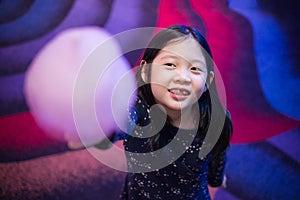 Asian Child Holding Cotton Candy in Hand with Smiling Face