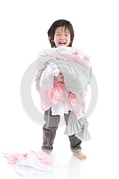 Asian child holding stack of t-shirts