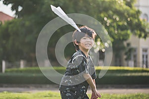 Asian child in kimono playing paper plane