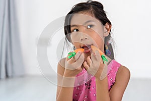 Asian child playing a chef at home