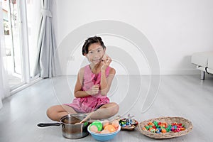 Asian child playing a chef at home.