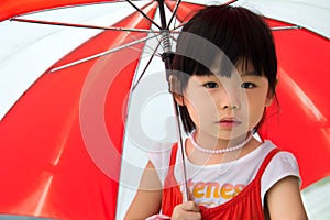 Asian child with red umbrella