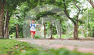 Asian child running to school