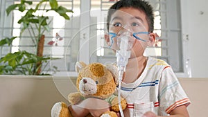 Asian Child using nebulizer mask equipment alone have smoke