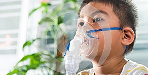 Asian Child using nebulizer mask equipment alone have smoke