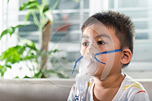 Asian Child using nebulizer mask equipment alone have smoke