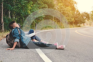 Asian children be tired after backpacking in nature background