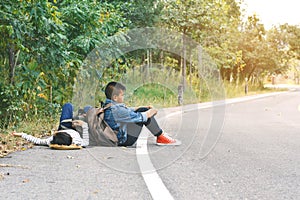 Asian children be tired after backpacking in nature background